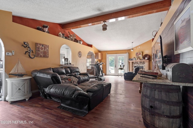 1942 Calusa Trl, Middleburg, FL 32068 - living area featuring arched walkways, dark wood-style flooring, a textured ceiling, and a fireplace