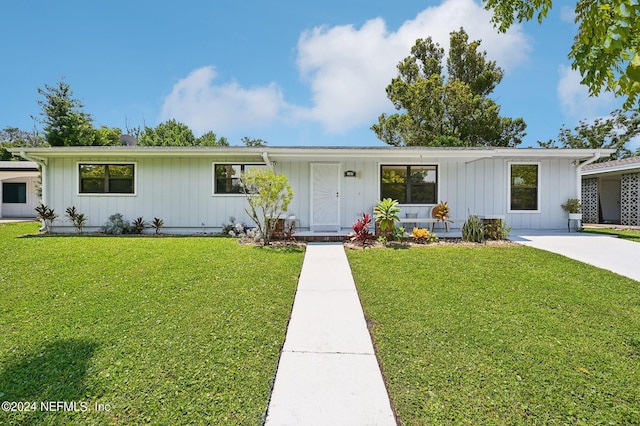 187 Deltona Blvd, Saint Augustine, FL 32086 - view of front of home with a front yard and board and batten siding