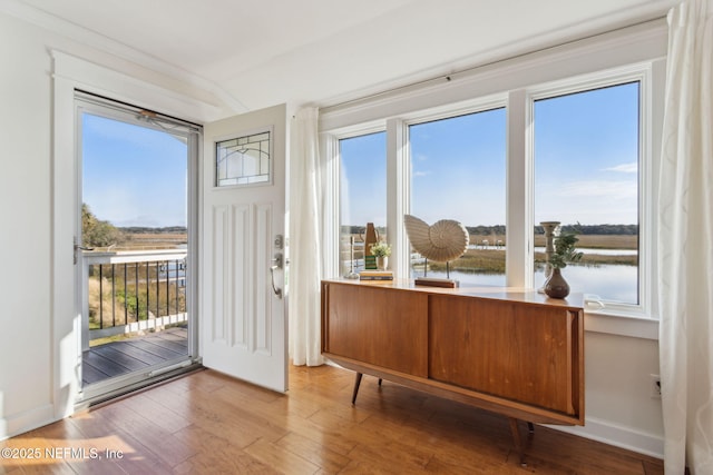 1912 Sunrise Dr, Fernandina Beach, FL 32034 - doorway to outside featuring wood-type flooring, a water view, and baseboards