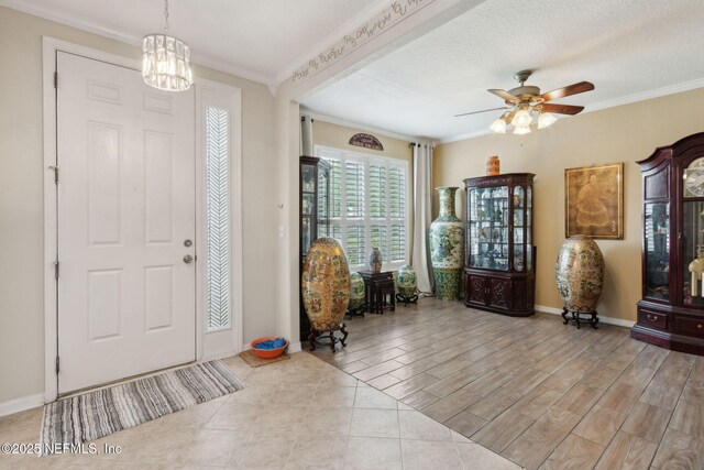 3592 Harrier Ct, Middleburg, FL 32068 - foyer featuring ornamental molding, a ceiling fan, a chandelier, and wood finished floors