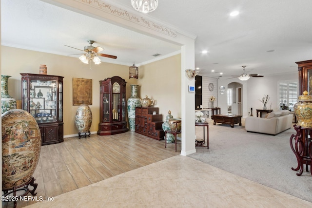 3592 Harrier Ct, Middleburg, FL 32068 - carpeted living area featuring ceiling fan, arched walkways, crown molding, and recessed lighting