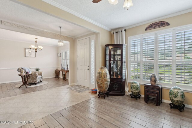 3592 Harrier Ct, Middleburg, FL 32068 - sitting room featuring wood finished floors, a chandelier, crown molding, and a ceiling fan