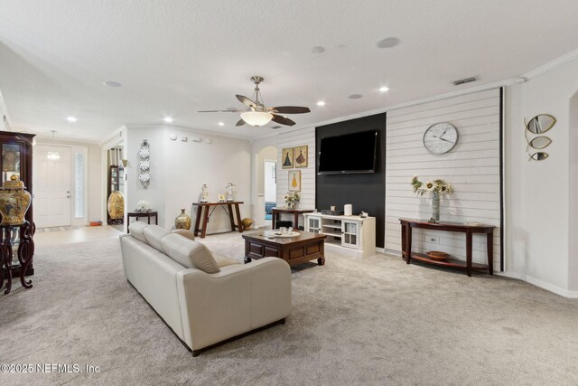 3592 Harrier Ct, Middleburg, FL 32068 - living room with ornamental molding, recessed lighting, carpet flooring, ceiling fan, and arched walkways