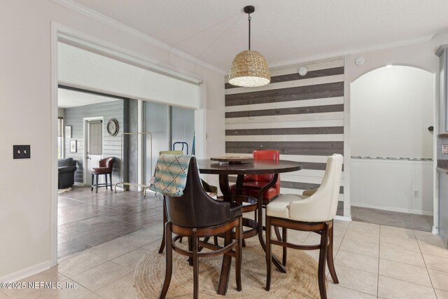 3592 Harrier Ct, Middleburg, FL 32068 - tiled dining area featuring crown molding and wooden walls