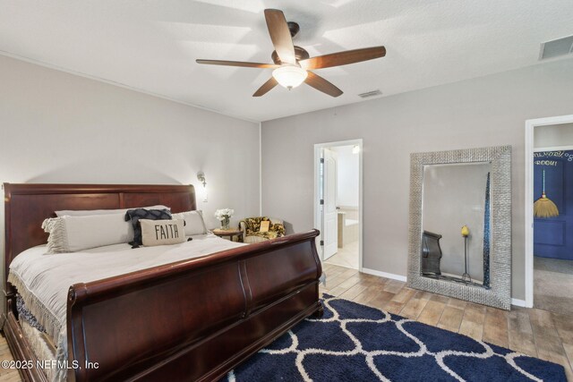 3592 Harrier Ct, Middleburg, FL 32068 - bedroom featuring wood finished floors, a ceiling fan, and connected bathroom
