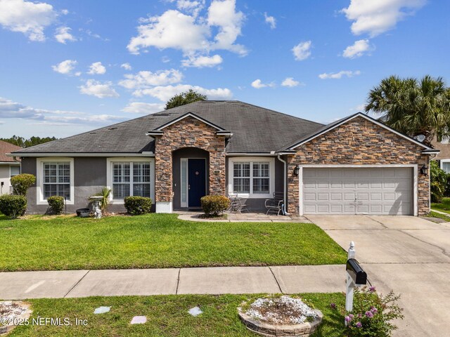 3592 Harrier Ct, Middleburg, FL 32068 - ranch-style home with stone siding, a front yard, driveway, an attached garage, and stucco siding