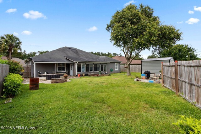 3592 Harrier Ct, Middleburg, FL 32068 - back of house with a fenced backyard, a patio area, an outbuilding, and a shingled roof