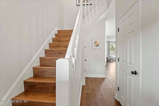 28 S Comares Ave, Saint Augustine Beach, FL 32080 - stairway featuring wood finished floors, baseboards, and a towering ceiling