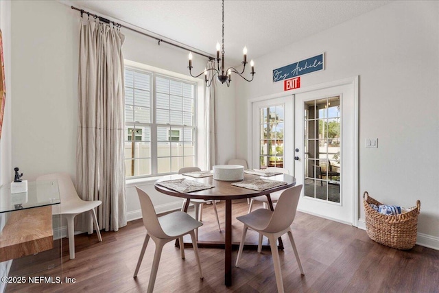 28 S Comares Ave, Saint Augustine Beach, FL 32080 - dining area with a chandelier, wood finished floors, and baseboards