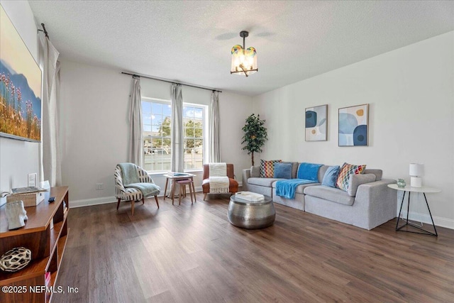 28 S Comares Ave, Saint Augustine Beach, FL 32080 - living room with wood finished floors, a textured ceiling, baseboards, and a chandelier