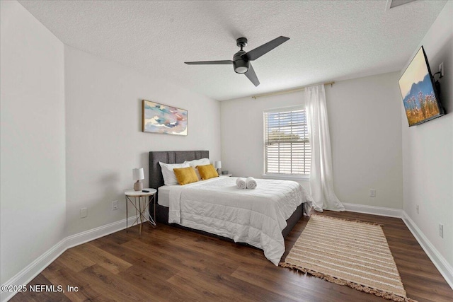 28 S Comares Ave, Saint Augustine Beach, FL 32080 - bedroom with wood finished floors, a textured ceiling, baseboards, and a ceiling fan