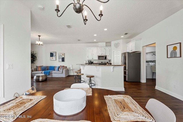 28 S Comares Ave, Saint Augustine Beach, FL 32080 - living area featuring a chandelier, a textured ceiling, dark wood-type flooring, recessed lighting, and baseboards