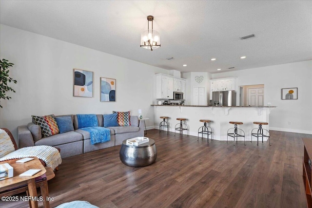 28 S Comares Ave, Saint Augustine Beach, FL 32080 - living room with dark wood-style floors, a chandelier, recessed lighting, and baseboards