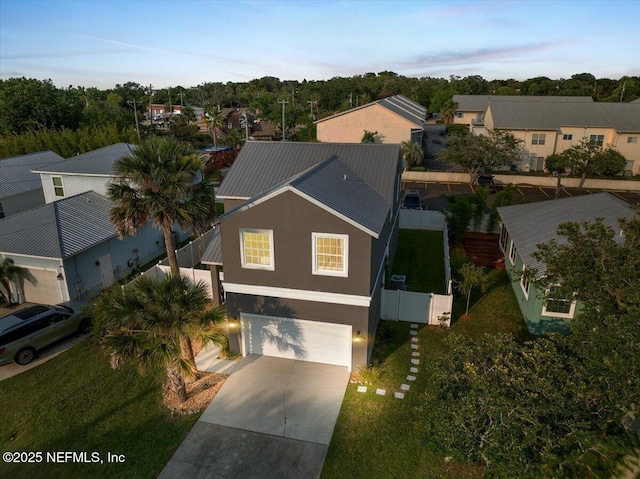 28 S Comares Ave, Saint Augustine Beach, FL 32080 - view of front of house with a garage, driveway, metal roof, a residential view, and stucco siding