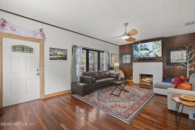 4524 Post St, Jacksonville, FL 32205 - living area with wood walls, wood-type flooring, ceiling fan, a fireplace, and baseboards