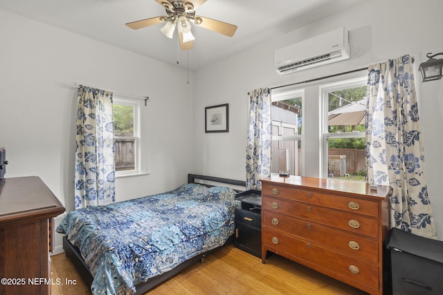 4524 Post St, Jacksonville, FL 32205 - bedroom with a wall mounted air conditioner, light wood-style flooring, and ceiling fan
