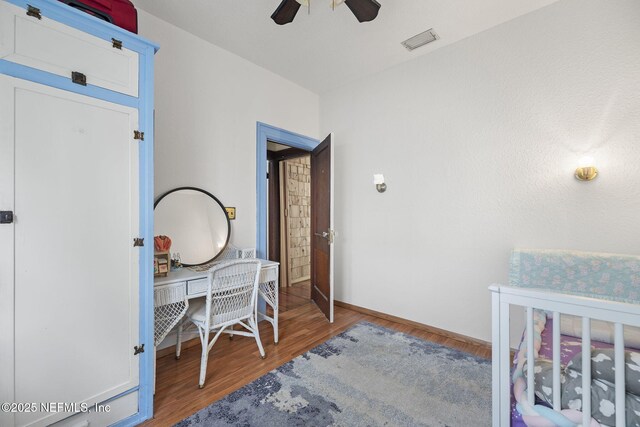 4524 Post St, Jacksonville, FL 32205 - bedroom with wood finished floors, an office area, baseboards, and ceiling fan