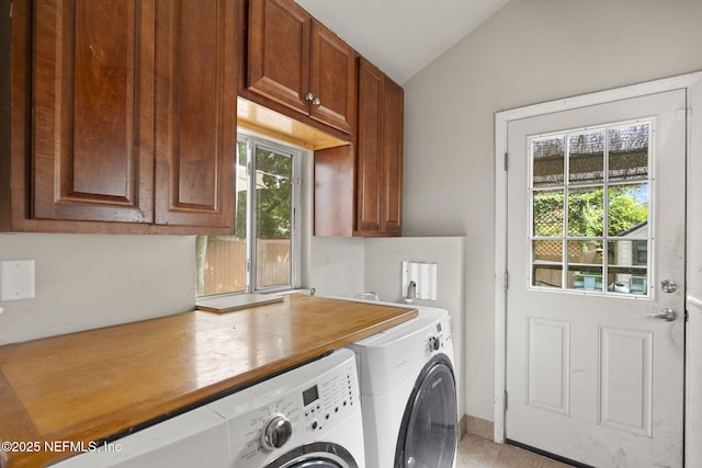 4524 Post St, Jacksonville, FL 32205 - laundry area featuring washing machine and dryer, cabinet space, and light tile patterned floors
