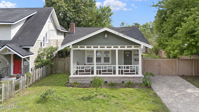 4524 Post St, Jacksonville, FL 32205 - view of front facade with a porch, a chimney, crawl space, and roof with shingles