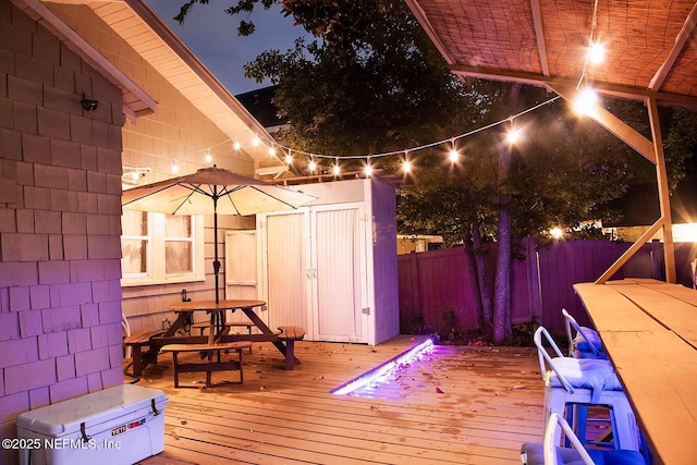 4524 Post St, Jacksonville, FL 32205 - deck at twilight with a fenced backyard and outdoor dining area