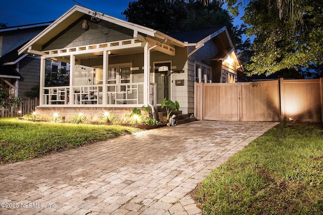 4524 Post St, Jacksonville, FL 32205 - view of front facade with a porch, driveway, and a gate
