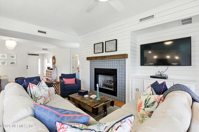 310 S Ocean Grande Dr Unit 205, Ponte Vedra Beach, FL 32082 - living room with a fireplace, ceiling fan, wood finished floors, and wood walls