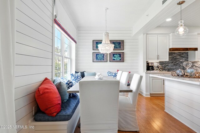 310 S Ocean Grande Dr Unit 205, Ponte Vedra Beach, FL 32082 - dining area with light wood-style floors, a chandelier, wooden walls, breakfast area, and recessed lighting