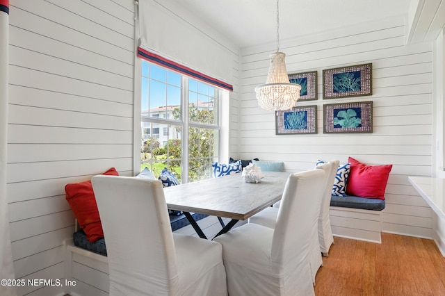 310 S Ocean Grande Dr Unit 205, Ponte Vedra Beach, FL 32082 - dining area featuring breakfast area, a chandelier, wood walls, and wood finished floors