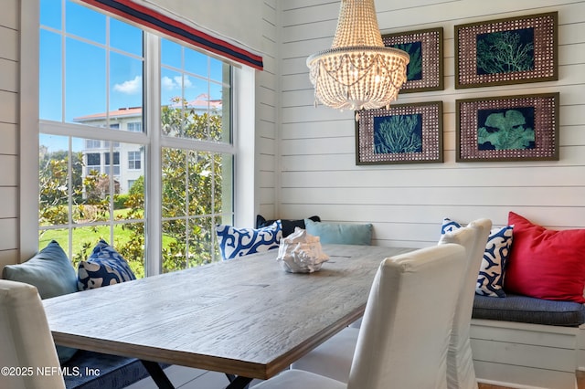 310 S Ocean Grande Dr Unit 205, Ponte Vedra Beach, FL 32082 - dining area featuring a chandelier, wooden walls, and breakfast area