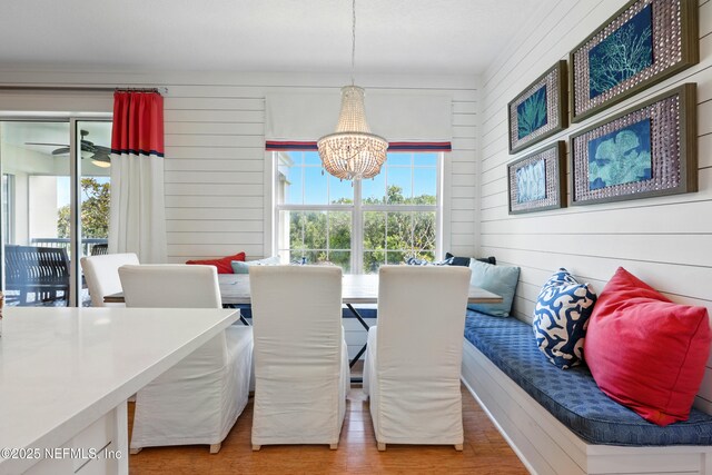 310 S Ocean Grande Dr Unit 205, Ponte Vedra Beach, FL 32082 - dining space with a chandelier, wood finished floors, and wood walls