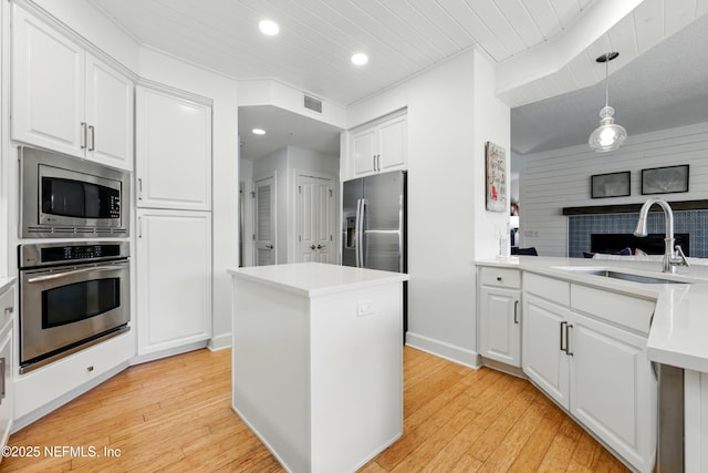 310 S Ocean Grande Dr Unit 205, Ponte Vedra Beach, FL 32082 - kitchen featuring stainless steel appliances, recessed lighting, wooden ceiling, white cabinets, and light wood-style flooring
