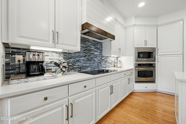 310 S Ocean Grande Dr Unit 205, Ponte Vedra Beach, FL 32082 - kitchen with appliances with stainless steel finishes, white cabinets, light countertops, decorative backsplash, and recessed lighting