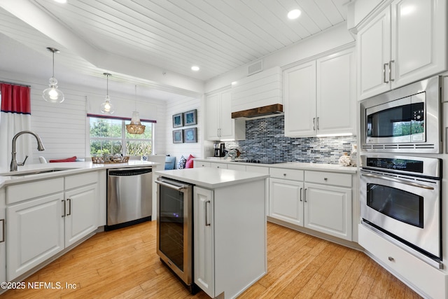 310 S Ocean Grande Dr Unit 205, Ponte Vedra Beach, FL 32082 - kitchen featuring appliances with stainless steel finishes, wine cooler, tasteful backsplash, light wood-type flooring, and recessed lighting