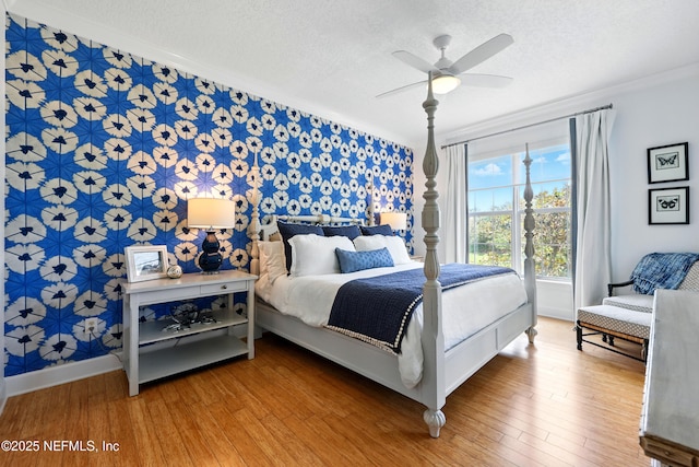 310 S Ocean Grande Dr Unit 205, Ponte Vedra Beach, FL 32082 - bedroom featuring wallpapered walls, crown molding, a textured ceiling, wood finished floors, and a ceiling fan