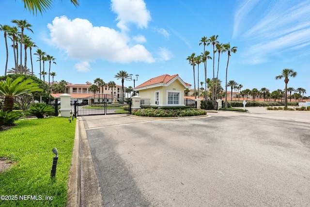 310 S Ocean Grande Dr Unit 205, Ponte Vedra Beach, FL 32082 - view of asphalt street with a gate, curbs, a gated entry, and street lighting