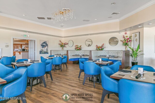 310 S Ocean Grande Dr Unit 205, Ponte Vedra Beach, FL 32082 - dining area featuring crown molding, wood finished floors, and a chandelier