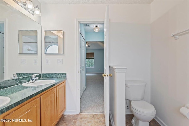 2888 Majestic Oaks Ln, Green Cove Springs, FL 32043 - bathroom with double vanity, a ceiling fan, and a textured ceiling