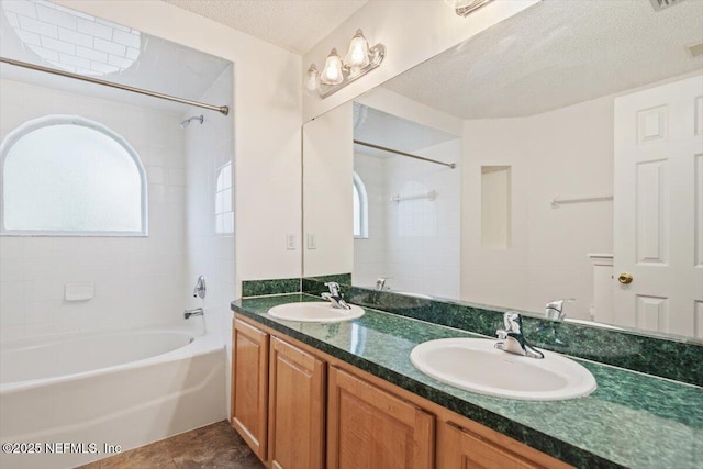 2888 Majestic Oaks Ln, Green Cove Springs, FL 32043 - bathroom featuring tub / shower combination, double vanity, and a textured ceiling