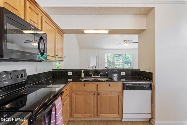2888 Majestic Oaks Ln, Green Cove Springs, FL 32043 - kitchen with black appliances, ceiling fan, dark stone counters, and a peninsula