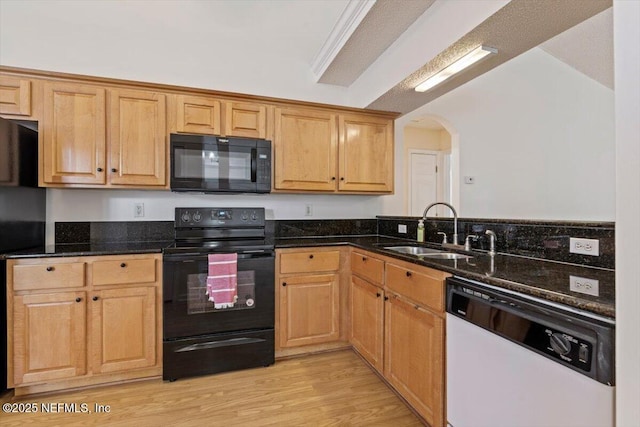 2888 Majestic Oaks Ln, Green Cove Springs, FL 32043 - kitchen featuring black appliances, arched walkways, dark stone countertops, light wood-style floors, and a peninsula