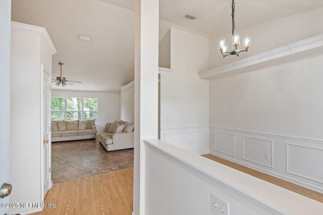 2888 Majestic Oaks Ln, Green Cove Springs, FL 32043 - hallway featuring light wood-style flooring, a chandelier, and a wainscoted wall