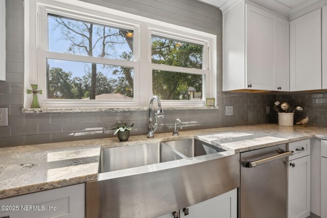 2808 Scott Mill Estates Dr, Jacksonville, FL 32257 - kitchen with a sink, tasteful backsplash, white cabinetry, and healthy amount of natural light