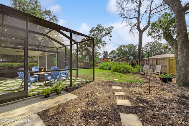 2808 Scott Mill Estates Dr, Jacksonville, FL 32257 - view of yard with a fire pit, a patio, and glass enclosure