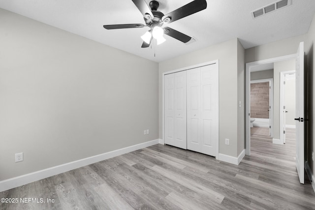 1731 W 28th St, Jacksonville, FL 32209 - unfurnished bedroom with wood finished floors, a closet, baseboards, and ceiling fan