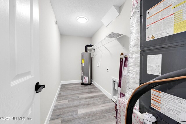 1731 W 28th St, Jacksonville, FL 32209 - exercise area featuring electric water heater, wood finished floors, and baseboards