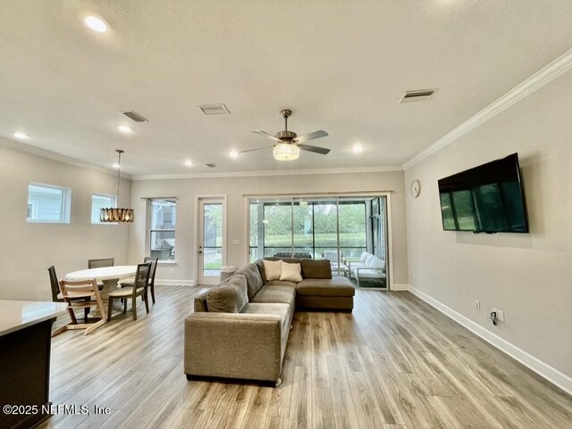 106 Shadow Ridge Trl, Ponte Vedra, FL 32081 - living room with light wood-style flooring, crown molding, recessed lighting, ceiling fan, and a chandelier