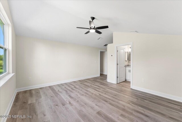 1790 N Lakeshore Dr, Fleming Island, FL 32003 - empty room featuring a ceiling fan, vaulted ceiling, wood finished floors, and baseboards