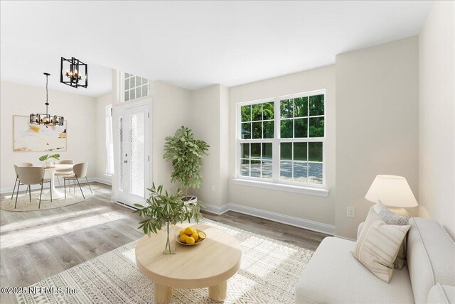 1790 N Lakeshore Dr, Fleming Island, FL 32003 - living room featuring a chandelier, wood finished floors, and baseboards