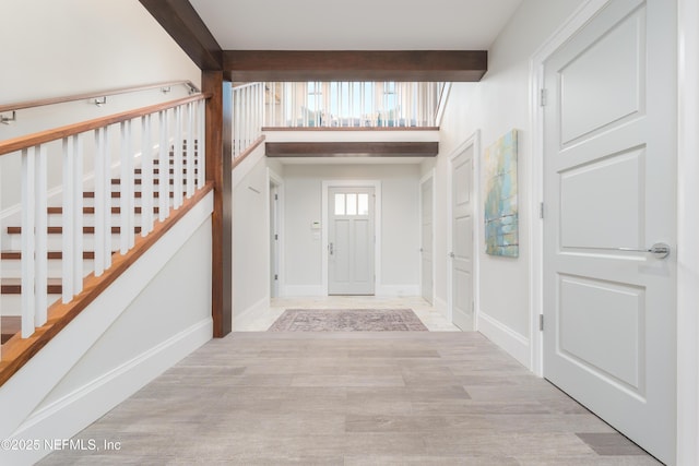 365 8th St, Atlantic Beach, FL 32233 - entrance foyer featuring beam ceiling, stairs, and wood finished floors