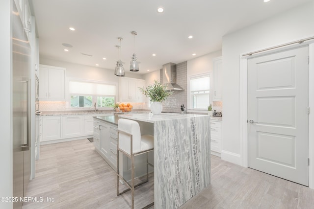 365 8th St, Atlantic Beach, FL 32233 - kitchen featuring wall chimney exhaust hood, plenty of natural light, tasteful backsplash, a center island, and recessed lighting